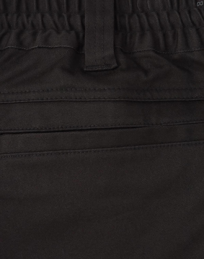 A close-up of black cotton stretch drill work shorts, featuring an elastic waistband and pockets.