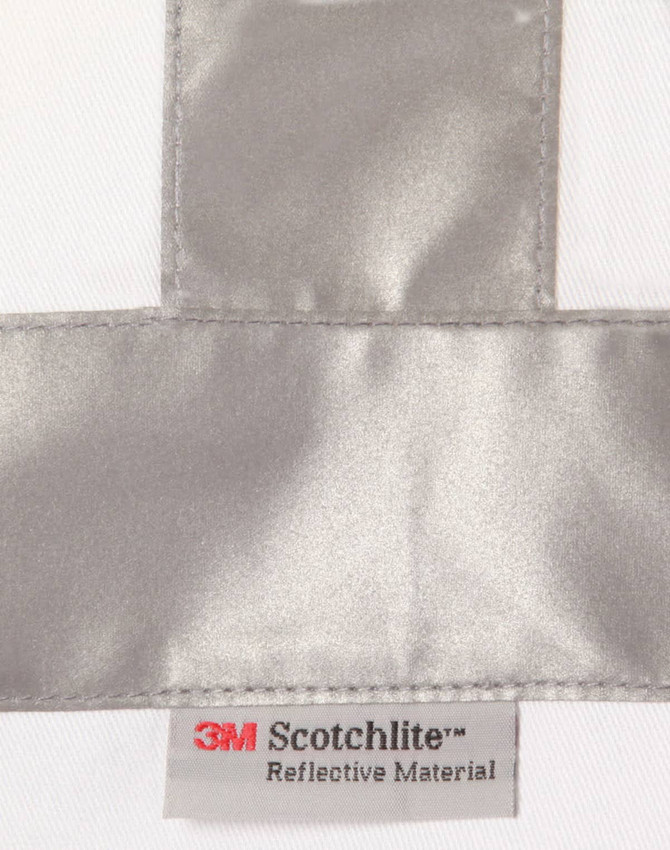 A reflective silver strip on a white fabric with a label for 3M Scotchlite reflective material.