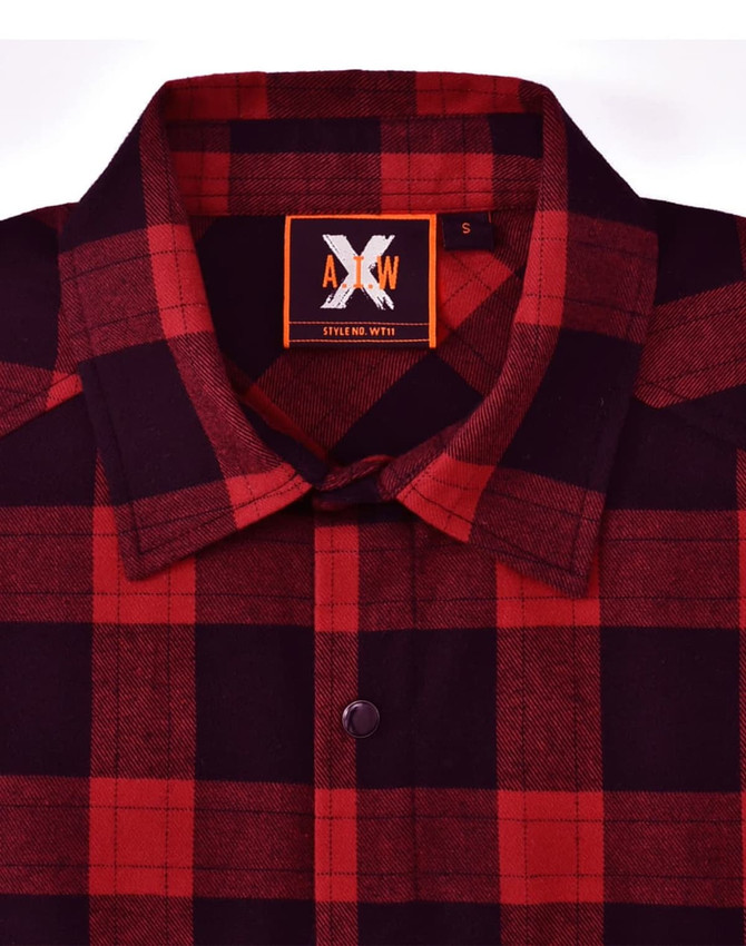 A unisex flannel plaid shirt in red and black with a button-up collar and a branded tag.