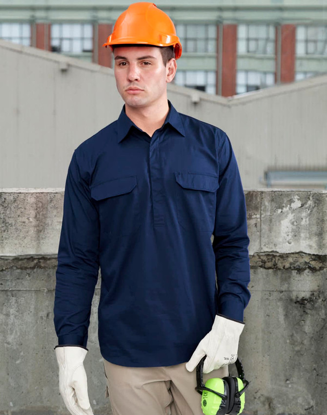 A navy long-sleeve work shirt with a closed front, featuring two chest pockets and worn by a model in a hard hat and gloves.