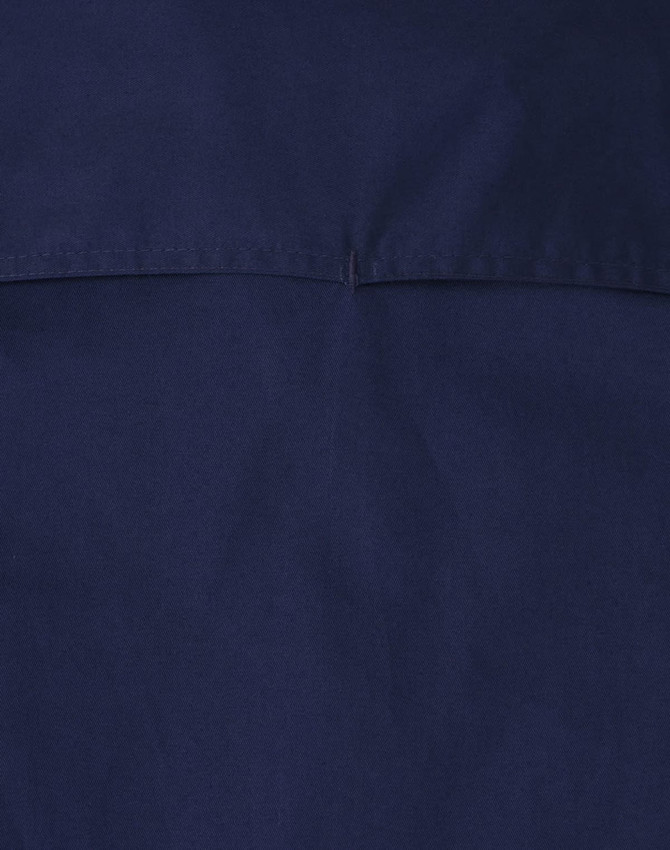A navy blue closed front long-sleeve work shirt featuring a simple design and a logo.