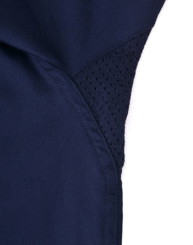 A close-up of a navy blue work shirt featuring a mesh panel for ventilation, with stitching details visible.