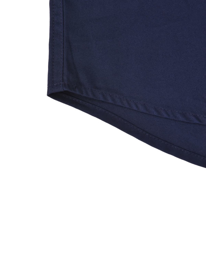 A navy blue long-sleeve work shirt with a closed front and a branded logo. Detailed hemline visible.