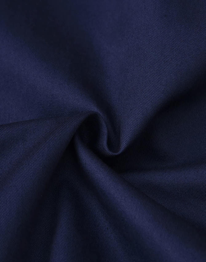 A close-up of navy fabric with a smooth texture, suitable for clothing. The fabric appears durable and lightweight.