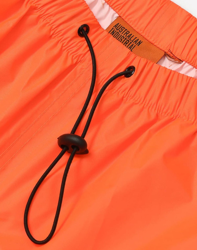 Lightweight nylon waterproof rain pants in bright orange with an adjustable waistband drawstring. Features a logo.