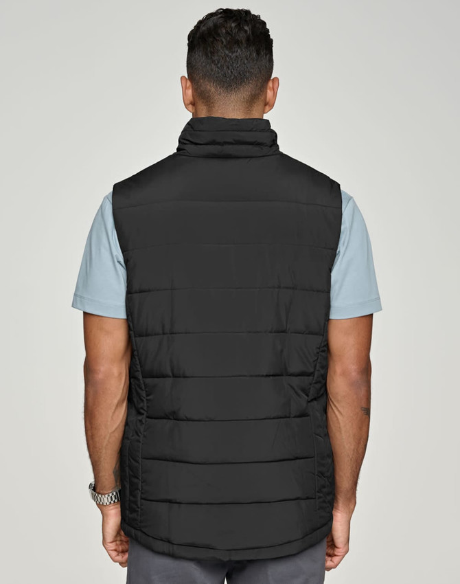 A black insulated puffer vest with a 3D cut, viewed from the back, worn over a light blue shirt.