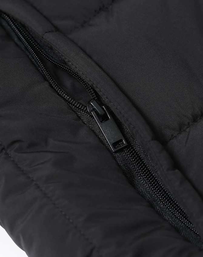 A close-up of a black insulated puffer vest featuring a zippered pocket and a quilted texture.