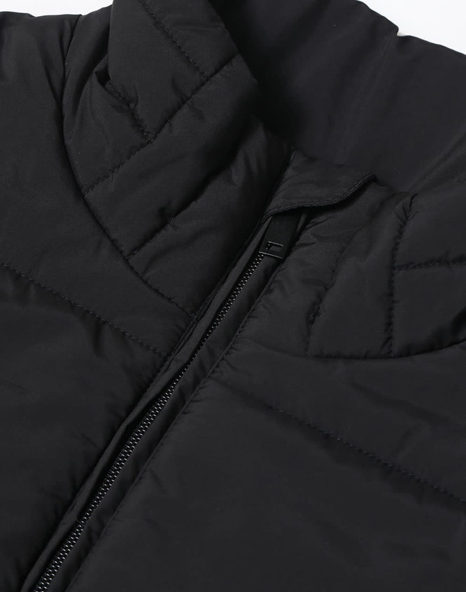 A black sustainable insulated puffer vest with a 3D cut and a zippered closure, featuring a logo.