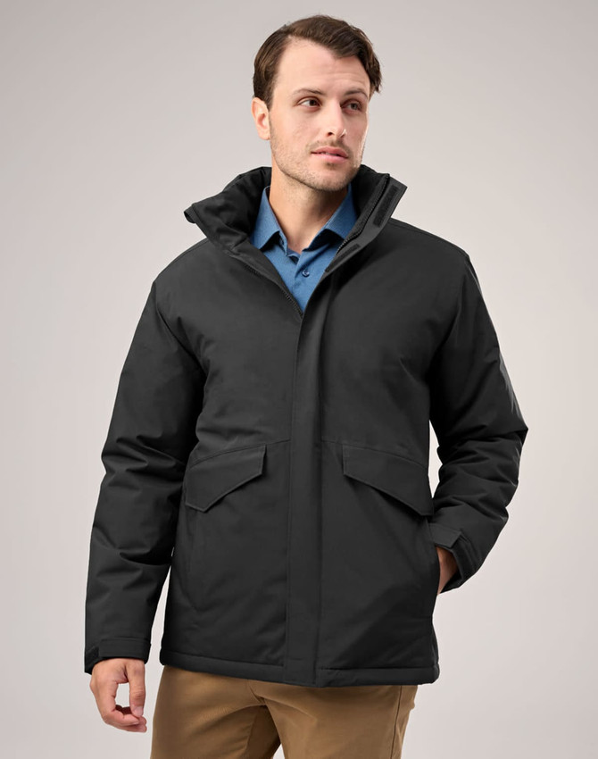 A black unisex quilted waterproof jacket with a hood and front pockets, worn by a model.