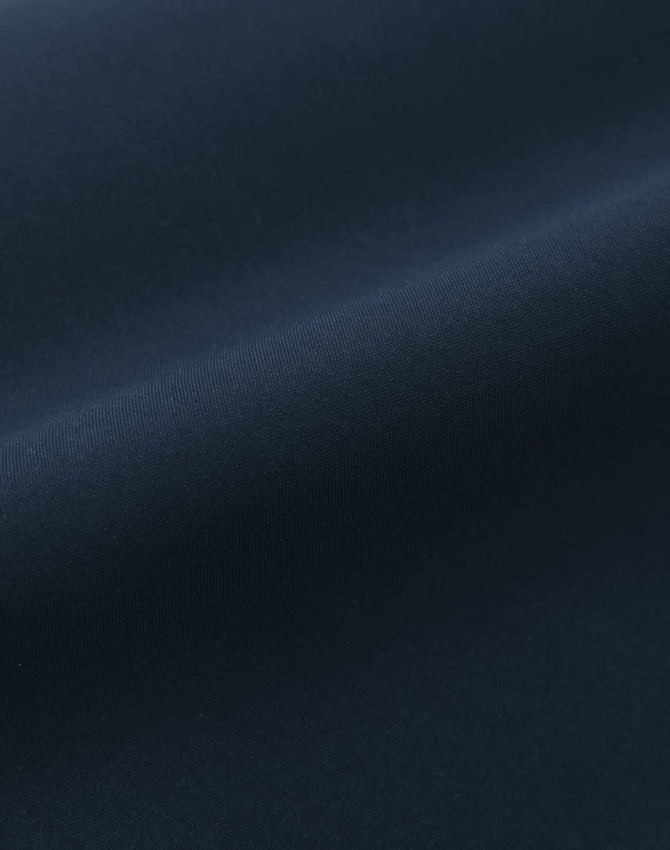 A smooth, dark navy fabric with a sleek finish, showcasing a quilted texture. It has a subtle sheen.