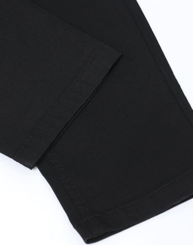 Black Men's Jean Style Flexi Chino Pants with a close-up view of the hem and fabric texture. Features logo branding.