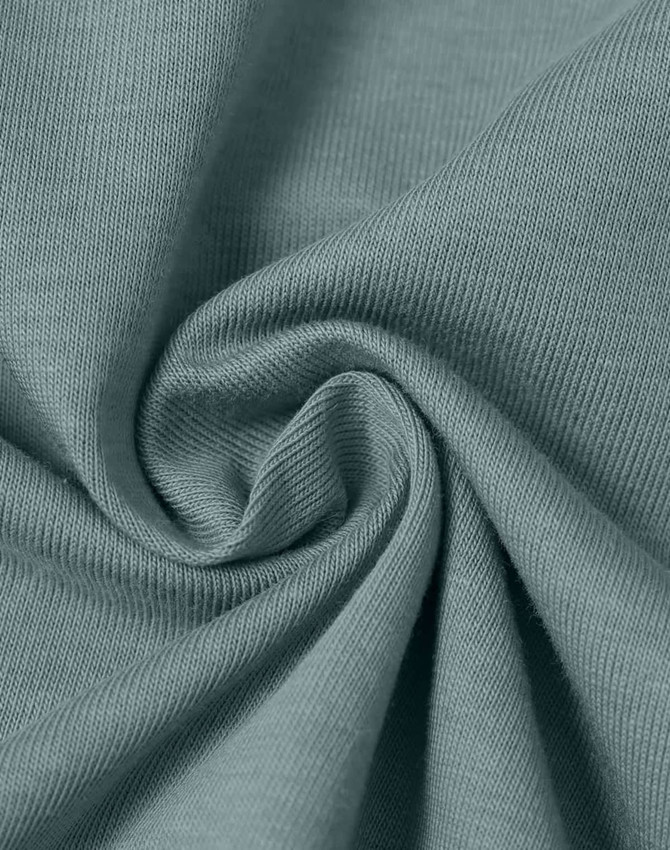 A close-up of a soft, lightweight, textured fabric in a muted teal colour, showcasing its smooth surface and drape.