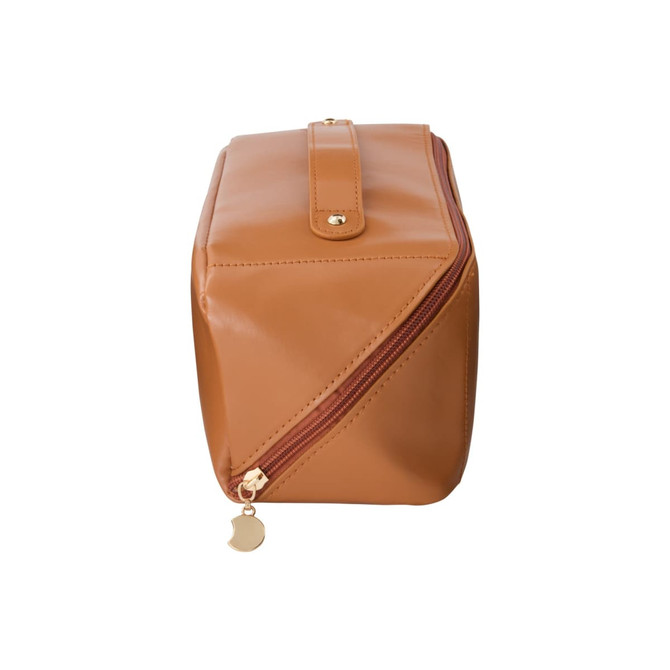 A tan toiletry bag with a gold zipper and a logo, featuring a rectangular design and a secure closure.