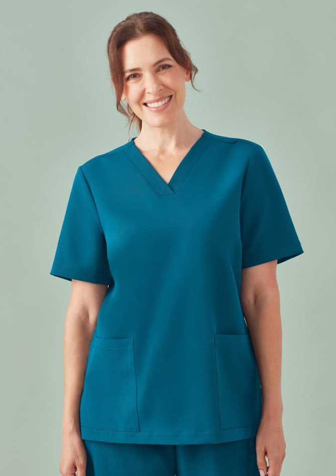 A teal women's V-neck scrub top with short sleeves and two front pockets. The top has a logo on it.