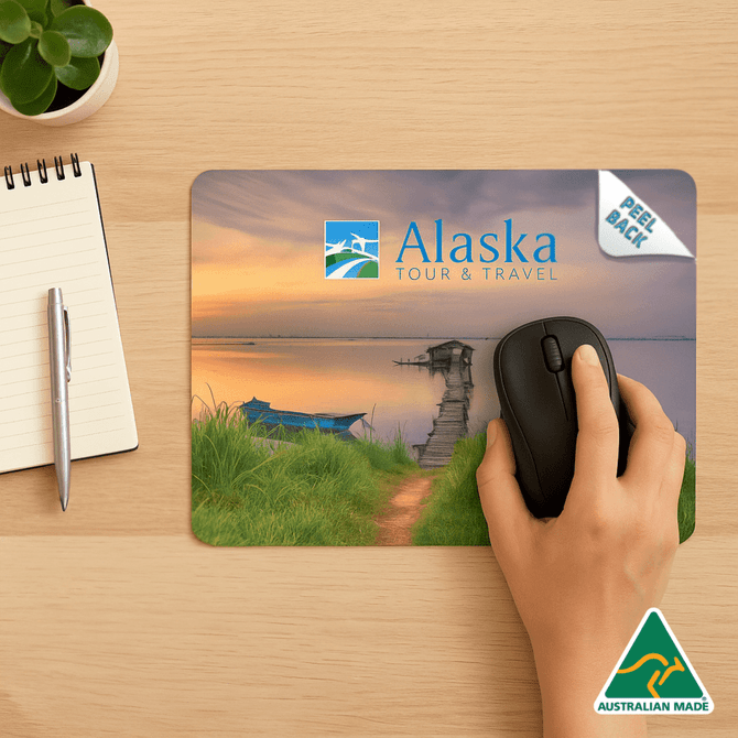 A mouse mat featuring a scenic landscape with a hand using a mouse, including a logo and branding. A mouse mat featuring a scenic landscape with a hand using a mouse, including a logo and branding.