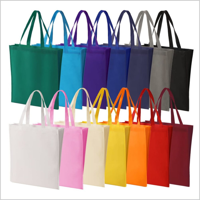 A collection of tote bags in various colours, including green, purple, blue, grey, black, white, pink, yellow, and orange.