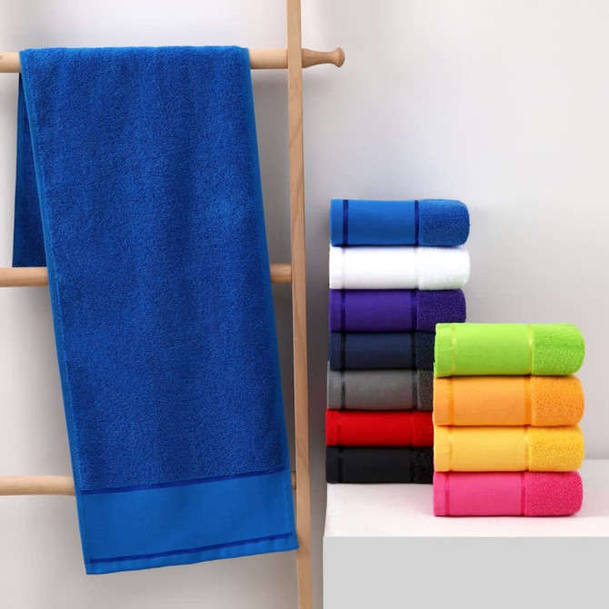 A blue gym towel hangs alongside a neatly stacked assortment of towels in various colours, including white, black, and orange.