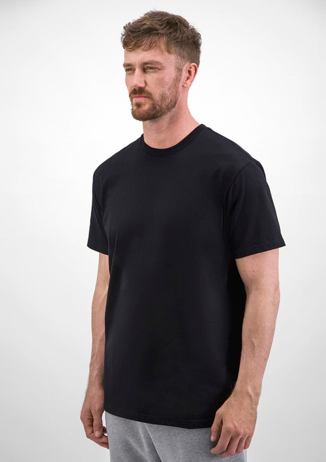 A black short sleeve tee worn by a man, featuring a simple design and a logo.