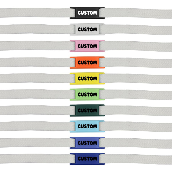 A row of white shoelaces featuring various coloured luxury shoelace charms in multiple designs and shades.