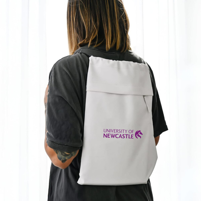 A white drawstring bag is worn on the back, featuring a logo. The bag has a minimalist design with a sleek appearance.