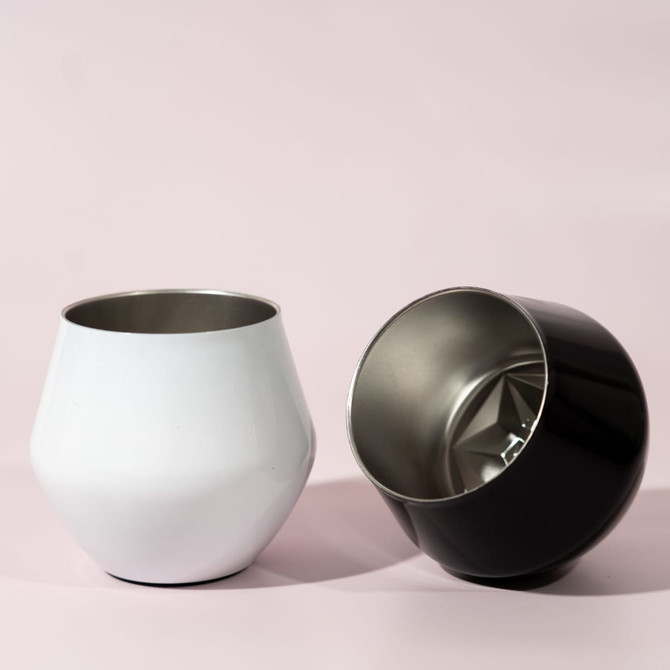 A detachable wine glass in white and black with a shiny stainless steel interior and a smooth exterior.