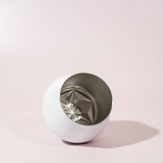 A detachable wine glass in a sleek white exterior with a metallic silver interior, featuring a diamond-patterned base.