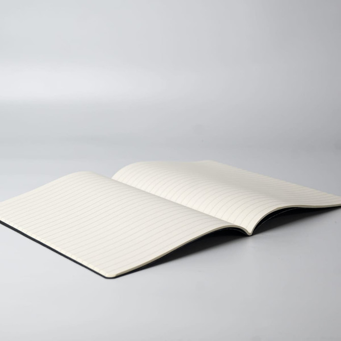 An open notebook with lined pages, featuring a plain black cover and a minimalist design.