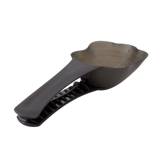 A pet food scoop in dark grey with a measuring section and a handle for easy grip. The product has a logo on it.