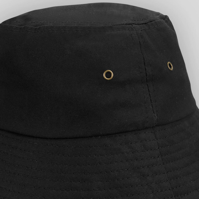 A black bucket hat featuring brass eyelets for ventilation and a textured finish. It has a simple design with no visible logos.