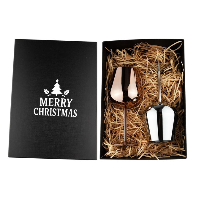 A stainless steel wine glass gift set featuring a rose gold and a white glass, presented in a black box with straw filler.