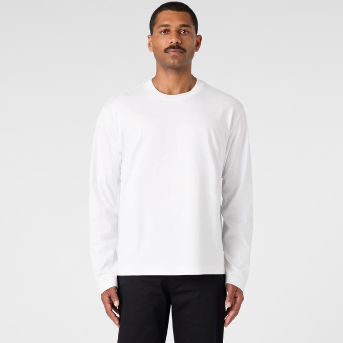 A long-sleeve white t-shirt worn by a model against a plain background. The shirt features a logo.