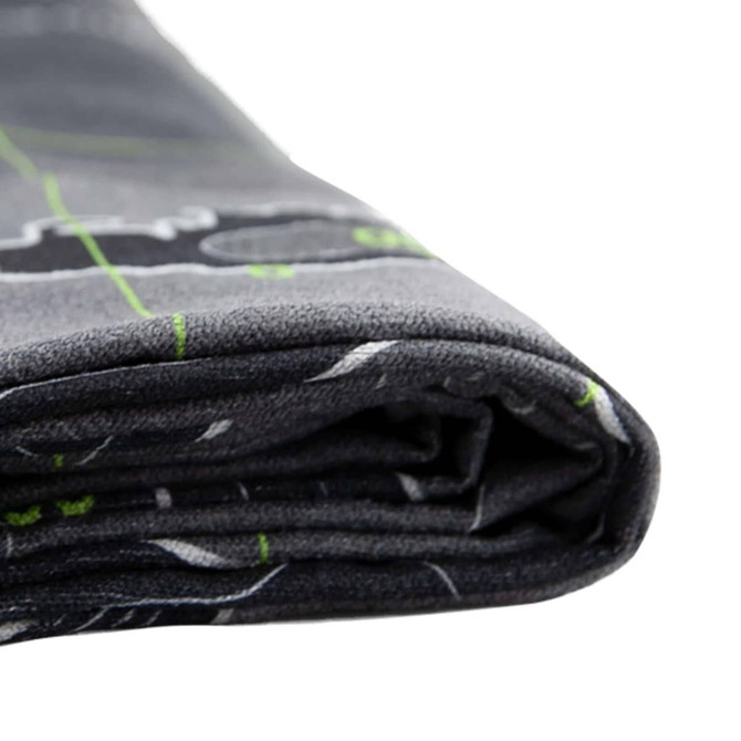 A folded grey beach towel featuring a design in green and white, with a logo visible on the fabric.