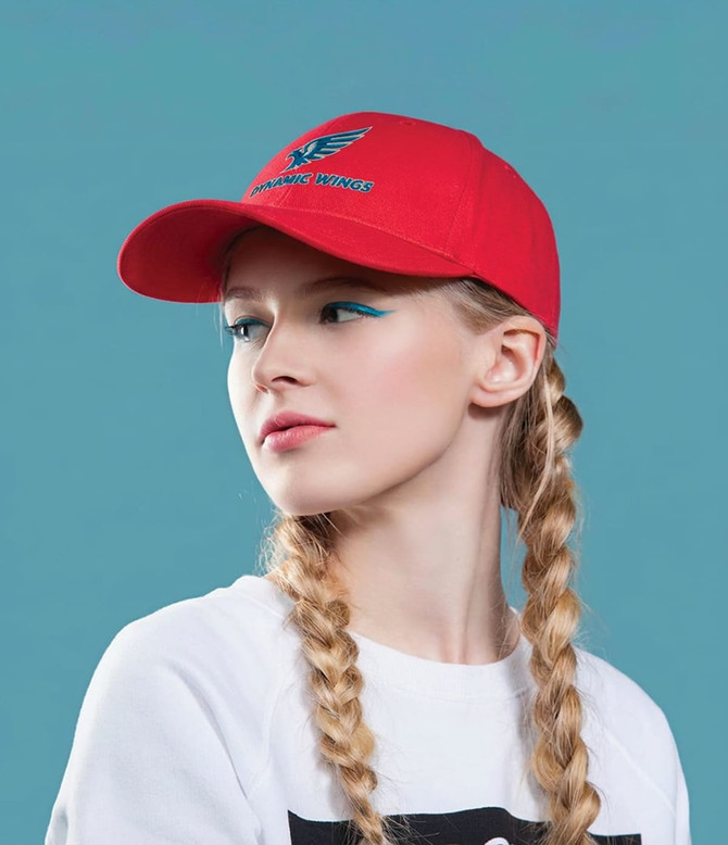 A red cotton twill cap with a buckle, featuring a logo, worn by a model with braided hair against a blue background.