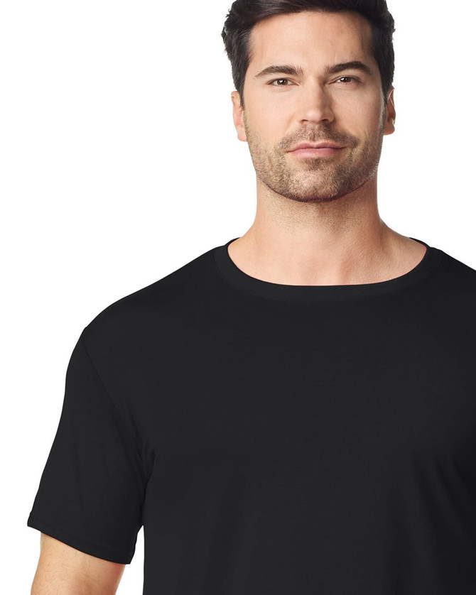 A black Gildan Performance adult t-shirt on a model, showcasing a classic crew neck and short sleeves.