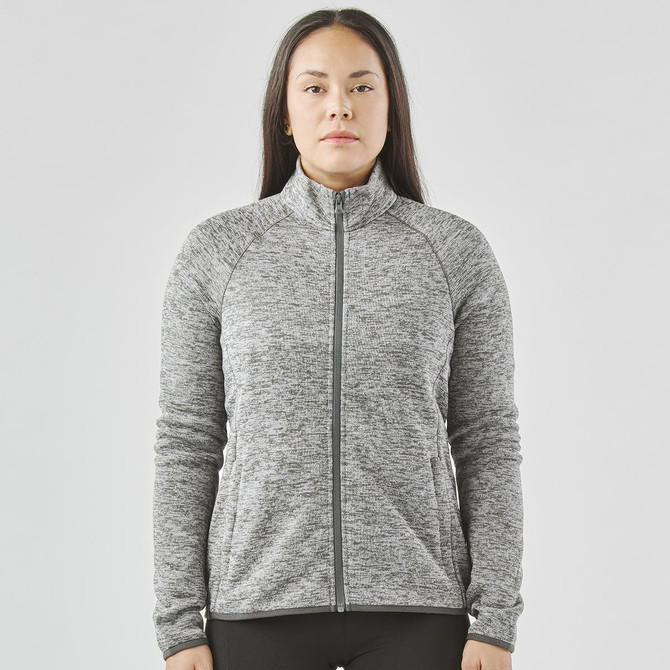 A women's full zip fleece jacket in grey with a high collar and long sleeves, featuring a logo.