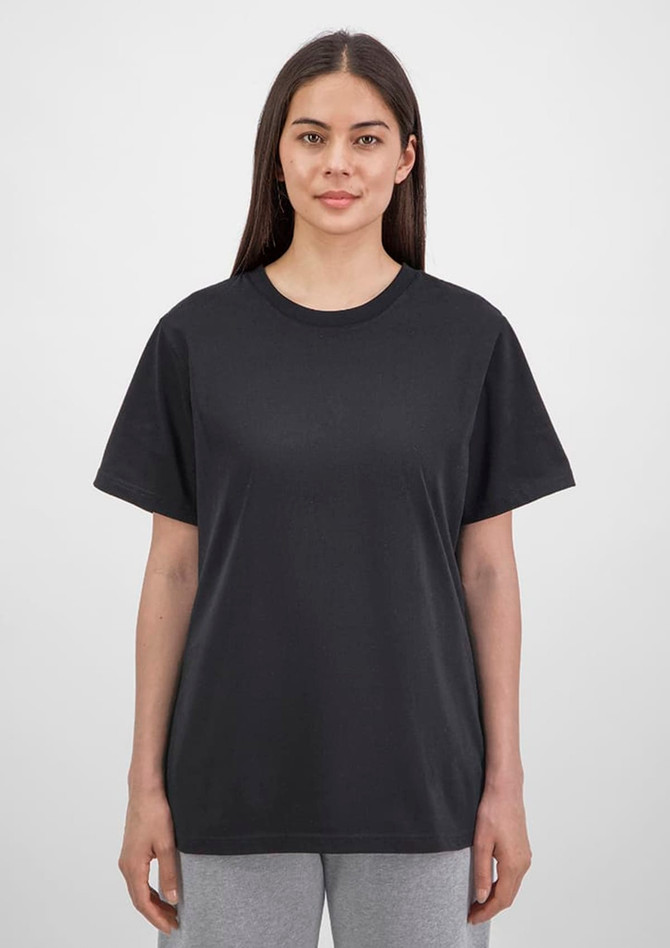 A black women's short sleeve tee is displayed on a model, featuring a simple design and relaxed fit.