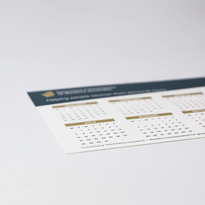 A magnetic calendar featuring a white background with gold accents, including dates for July and other months.