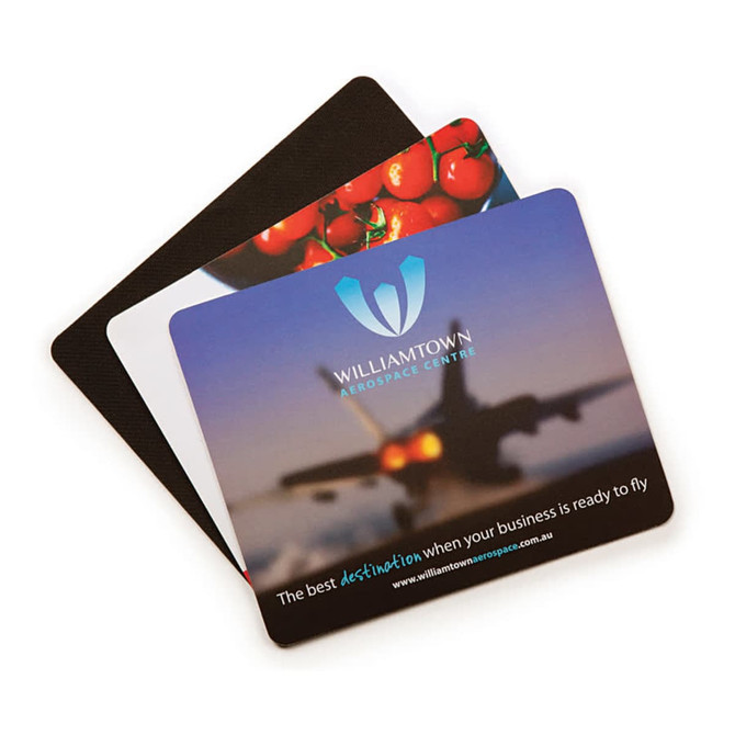 A mouse mat featuring a colourful design with an image of tomatoes and an aeroplane, and includes a logo.