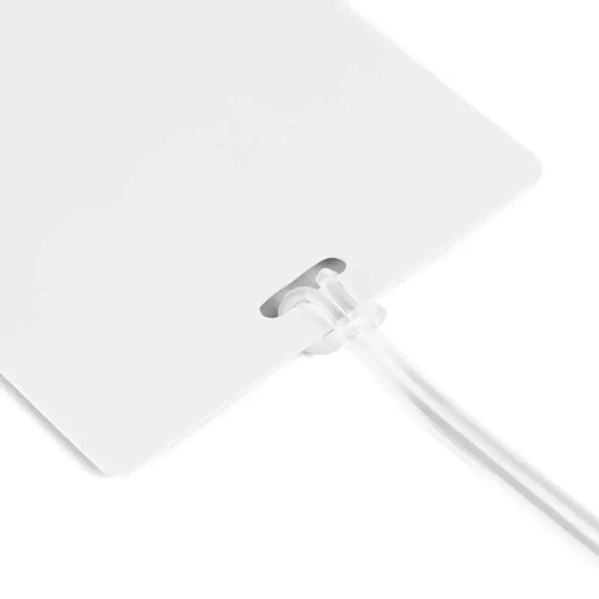 A large white luggage tag with a clear attachment loop, designed for easy identification.