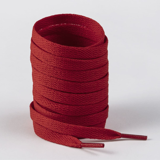A roll of red shoelaces with tapered ends, neatly stacked and ready for use, featuring a logo.