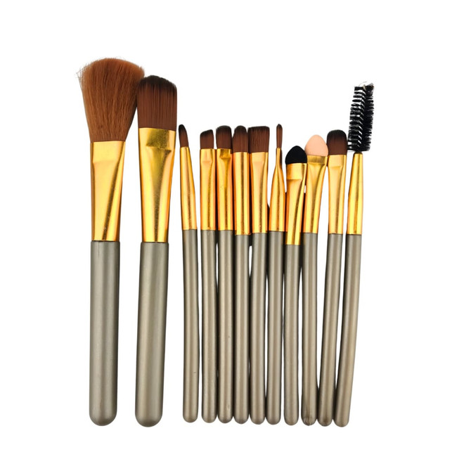 A 12-piece brush set featuring various brush types with gold ferrules and grey handles, stored in a metal box.