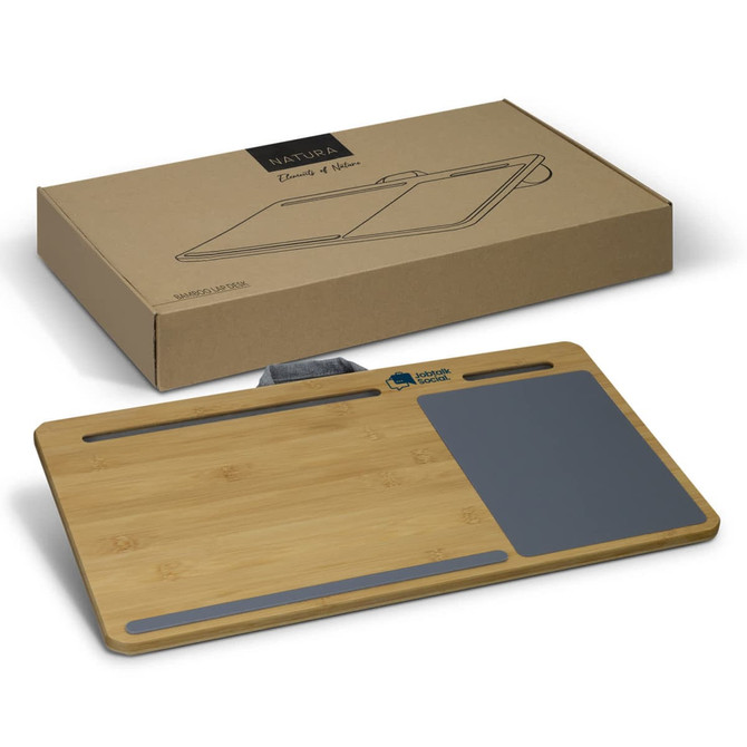 A bamboo lap desk in natural colour with a grey area and a logo, positioned next to its cardboard packaging.