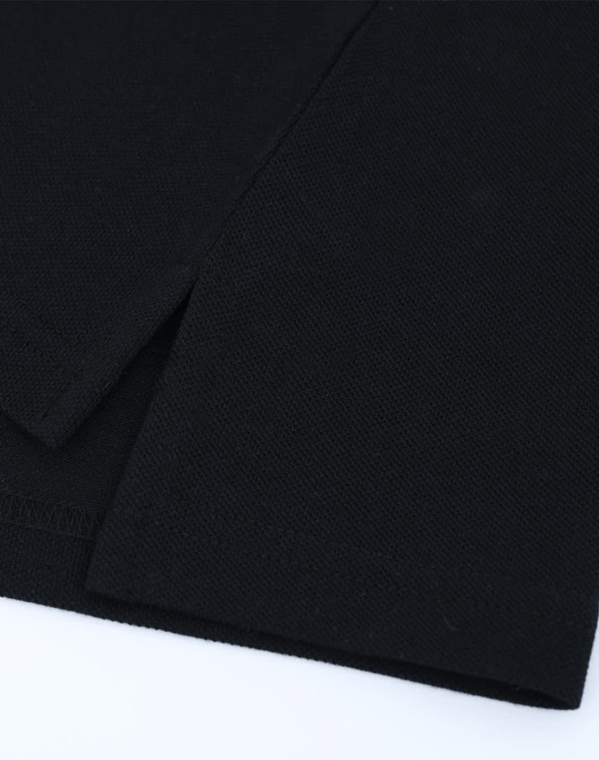 A black cotton/poly pique polo featuring a classic short-sleeve design and a subtle logo.
