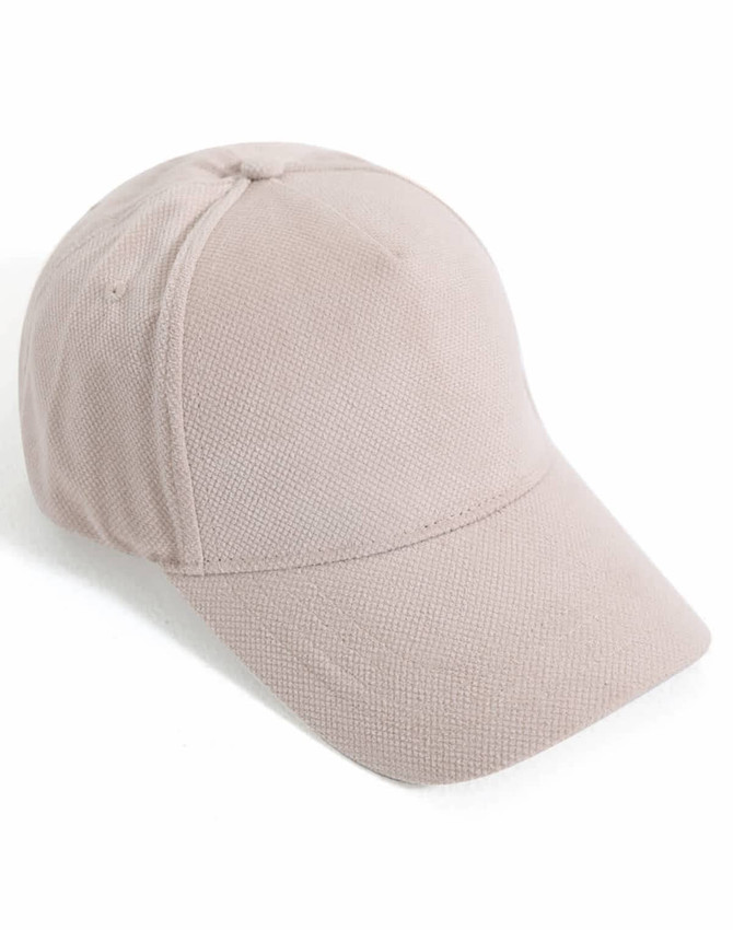 A light beige jacquard texture 5-panel cap with a curved brim and a branded logo.