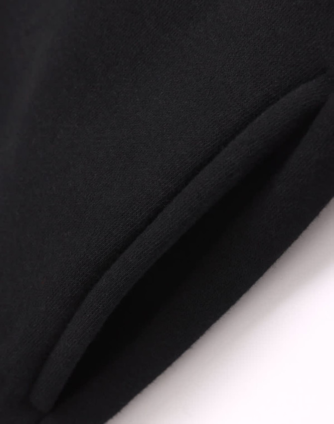 A black fleece half-zip collar sweatshirt featuring a textured fabric and a logo.