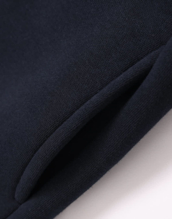 A navy fleecy sweatshirt featuring a half zip collar and a smooth fabric finish. It has a branded logo.