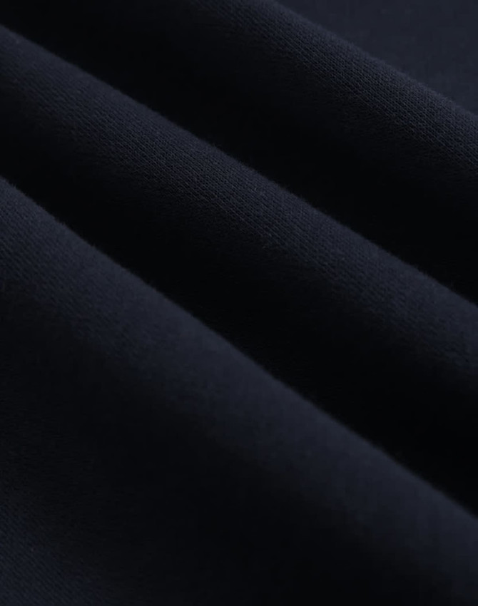 A close-up of dark navy fleece fabric, showcasing its soft texture and smooth finish.
