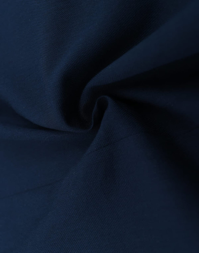 Dark navy cotton blend fabric with a smooth texture and subtle sheen, featuring a spiral fold.