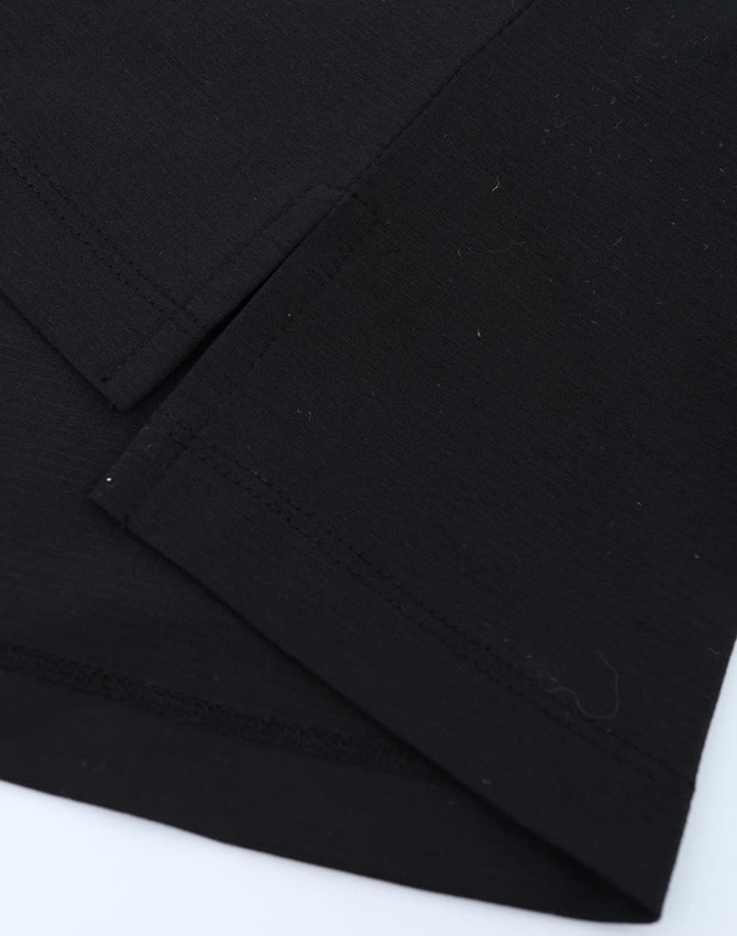 A close-up of a black polo shirt featuring short sleeves and smooth fabric texture. It includes a small logo.
