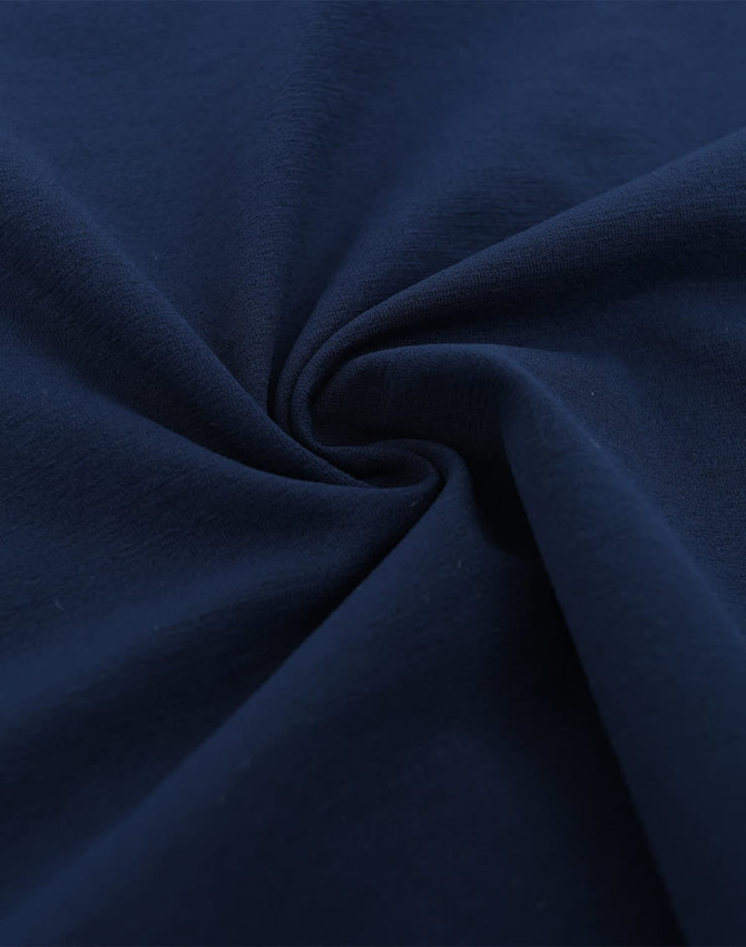 A close-up of navy fabric with a smooth texture, featuring a spiral pattern. The fabric appears high-quality and lightweight.